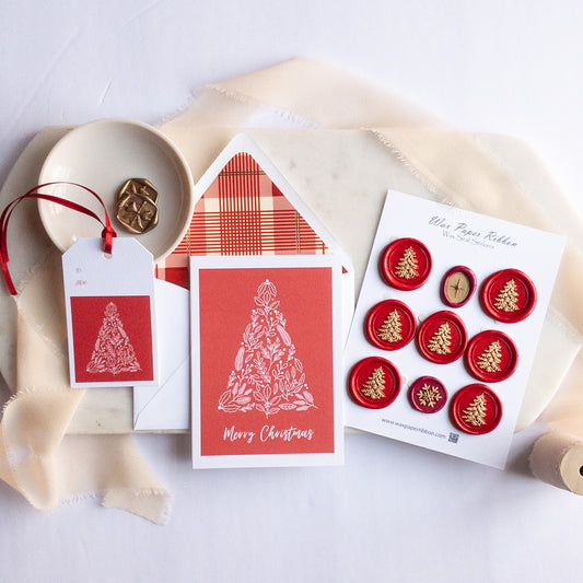 Christmas-themed stationery items including cards and seals on a white background